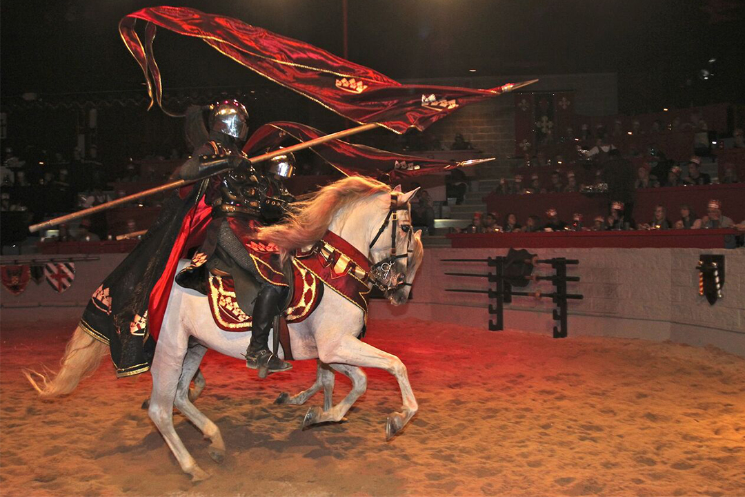 Man riding a horse holding a javelin