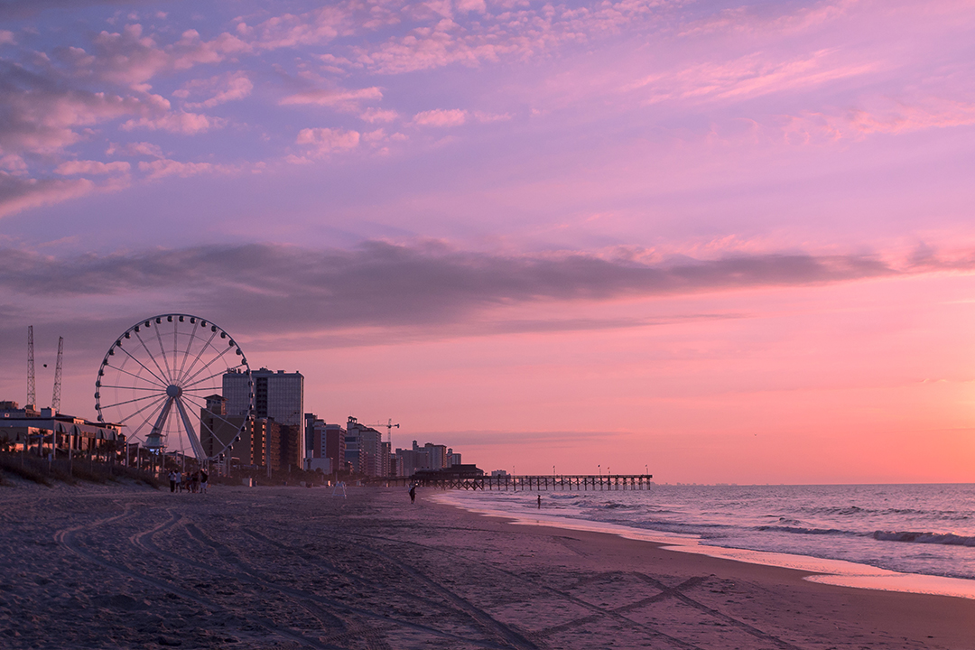 Sunset on the beach with the SkyWheel in the background