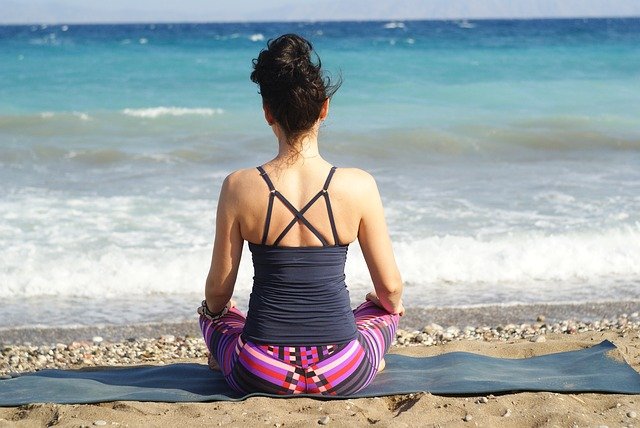 Women on Beach Doing Yoga