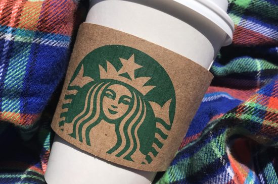 Starbucks cup with flannel background Starbucks cup with flannel background