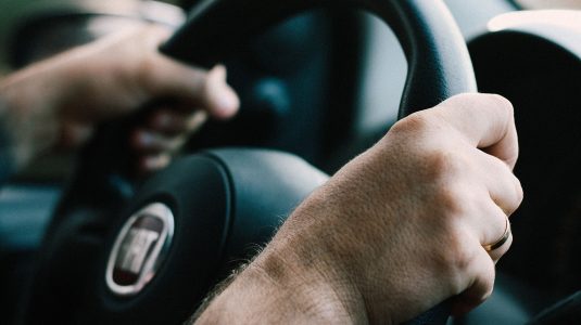 two hands holding the steering wheel