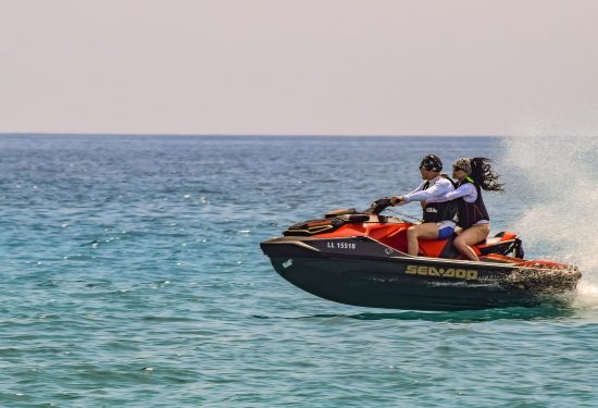 couple jetskiing on the ocean couple jetskiing on the ocean