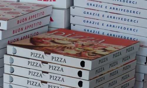 pizza boxes at the restaurant stacked