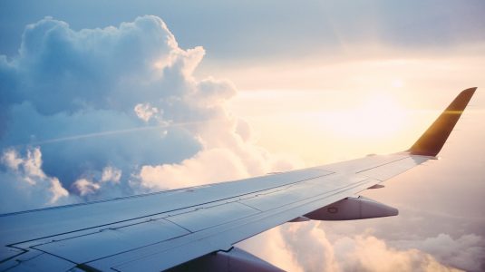 The wing of the plane over the clouds