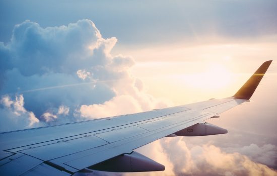 The wing of the plane over the clouds