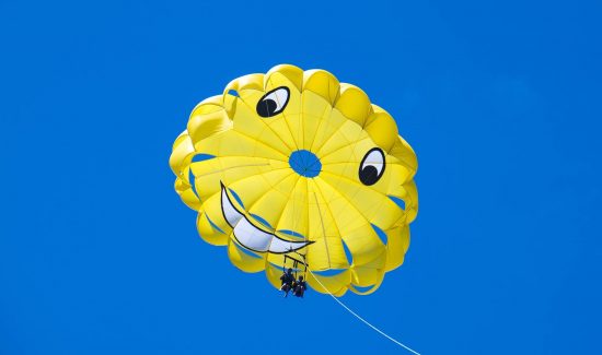couple parasailing in the sky