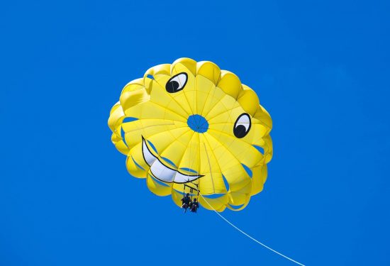 couple parasailing in the sky